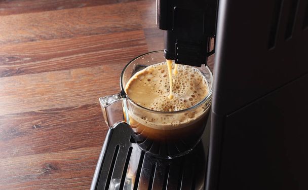 coffee glass espresso coffee machine wooden background - Foto, Bild