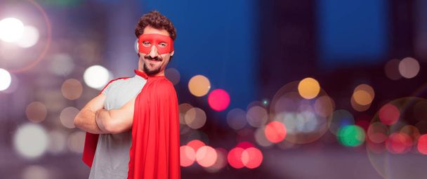 crazy man as a super hero with a proud, happy and confident expression; accepting a challenge with arms crossed, smiling and sure of success, giving an "achiever" look. - Foto, imagen