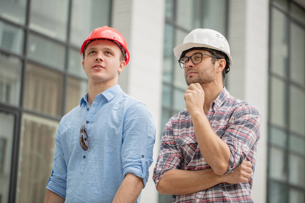 two awesome builders thinking about the design of construction - Fotografie, Obrázek