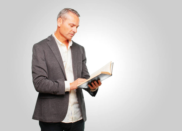 handsome senior man holding a book - Φωτογραφία, εικόνα