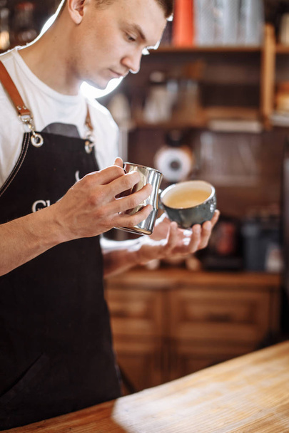 handsome man is making latte - Fotó, kép