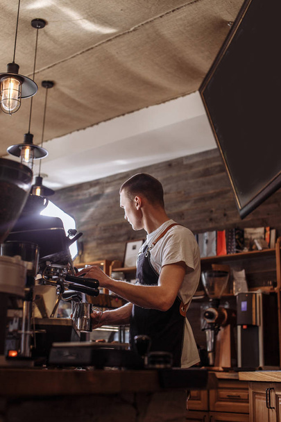 close up back view photo of a young man making cappuccino - Фото, зображення