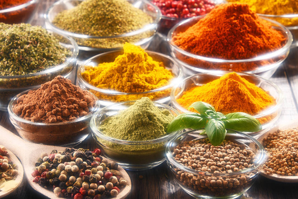 Variety of spices and herbs on kitchen table. - Valokuva, kuva