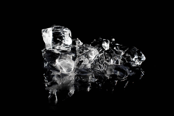 Top view of a pile of melting fresh ice arranged on black background of studio - Фото, изображение