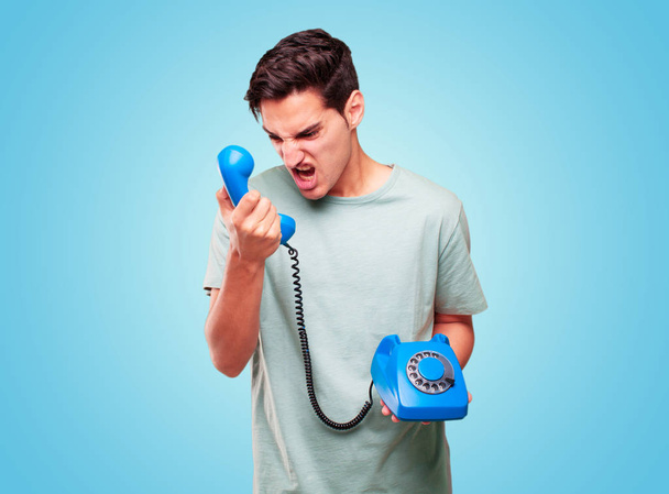 young handsome tanned man with a vintage telephone - Photo, Image