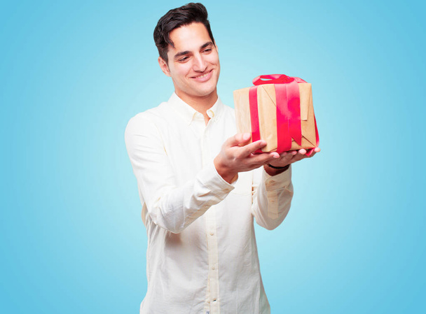 young handsome tanned man with gift box concept - Photo, image