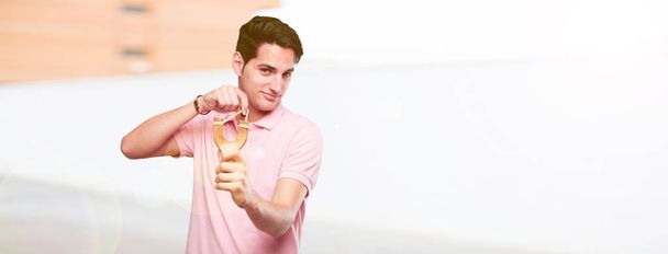 young handsome tanned man with a slingshot - Fotó, kép