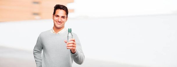 young handsome tanned man water bottle - Foto, immagini