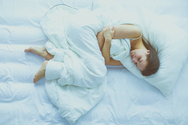 Young female feeling pain in bed. - Fotoğraf, Görsel