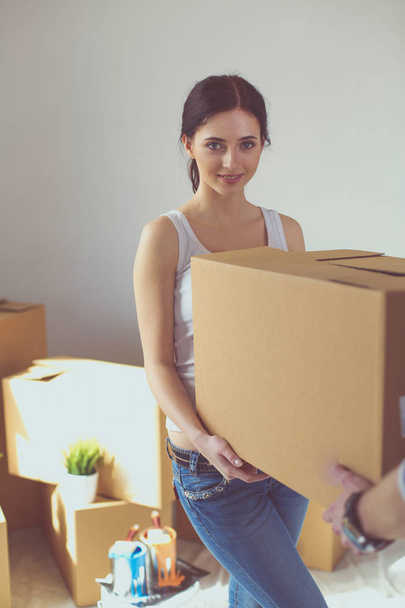 Happy young couple unpacking or packing boxes and moving into a new home. young couple - Foto, Imagem