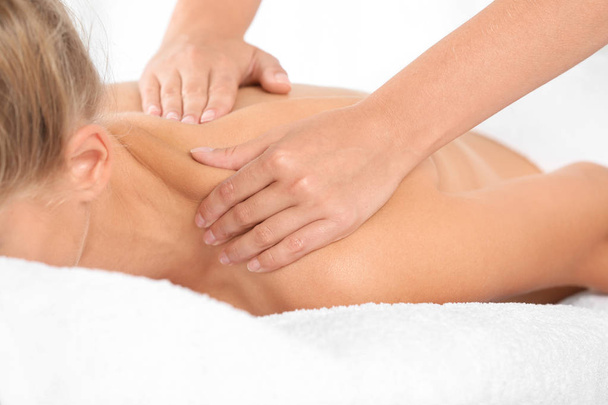Relaxed woman receiving shoulders massage in wellness center - Zdjęcie, obraz