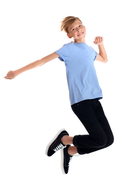 Portrait of young boy jumping on white background - Fotoğraf, Görsel