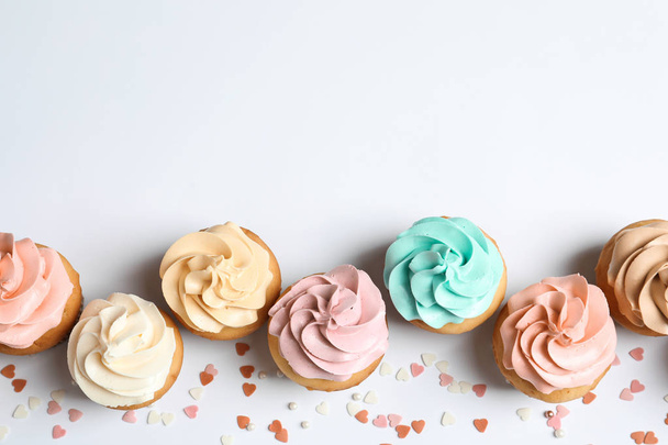 Flat lay composition with delicious birthday cupcakes and space for text on white background - Foto, immagini