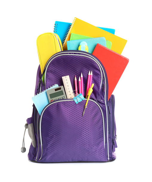 Color backpack with stationery on white background. Ready for school - Фото, зображення