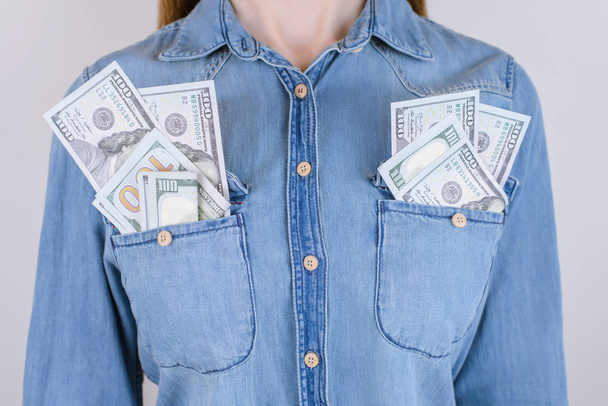 Happy happiness dream person people receive work job usa us bonus prize spend manager boss concept. Cropped close up photo of lady keeping much many pile stack bundle in pocket isolated on background - Photo, Image