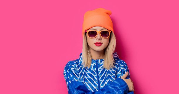 girl in 90s sports jacket and hat with sunglasses - 写真・画像