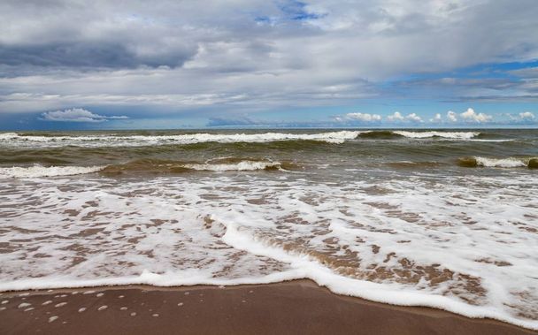 Storm in the sea with a cloudy sky and foam on the water. - Photo, Image