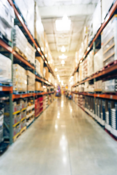Vintage tone blurred image of shelves in modern distribution warehouse or storehouse. Defocused background of industrial warehouse interior aisle. inventory, wholesale, logistic and export concept - Photo, image