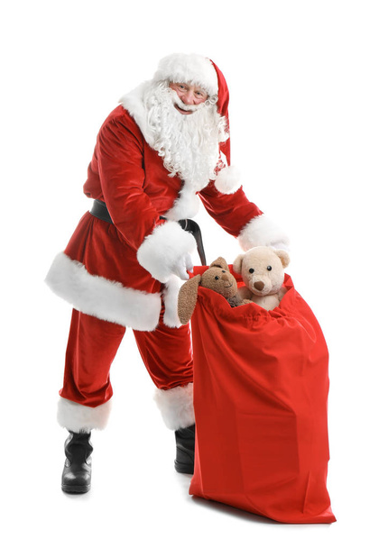 Authentic Santa Claus with red bag full of gifts on white background - Фото, изображение