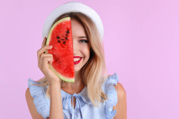 Pretty young woman with juicy watermelon on color background - Фото, изображение