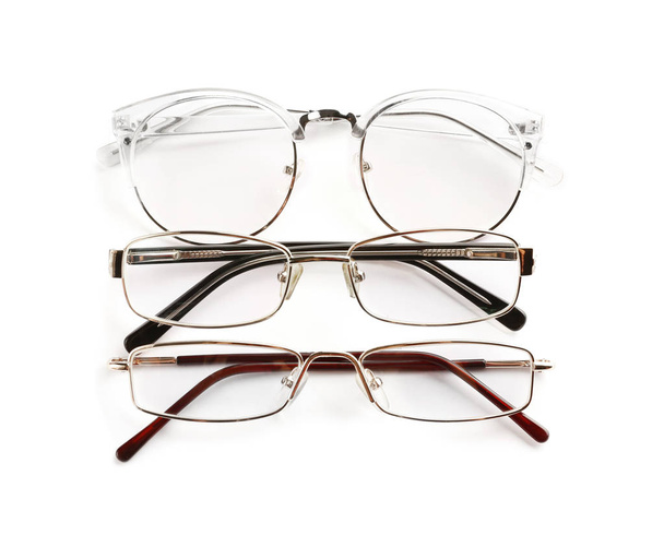 Different glasses with corrective lenses on white background. Vision problem - Fotografie, Obrázek