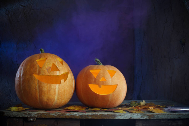 Halloween pumpkins on wooden table on dark background - Фото, зображення