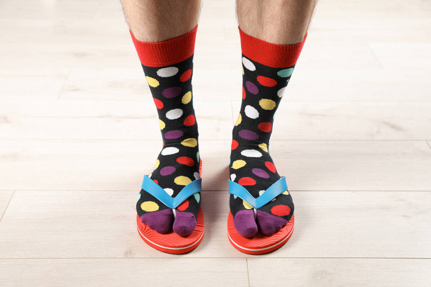 Man in socks and slippers on floor, closeup - Photo, Image