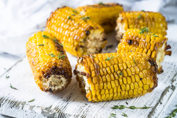 Grilled corn with spices on white. - Zdjęcie, obraz