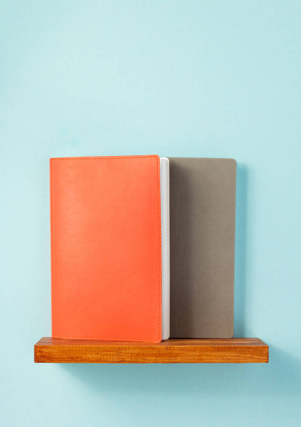 notepad and book on shelf at wall background surface - Valokuva, kuva