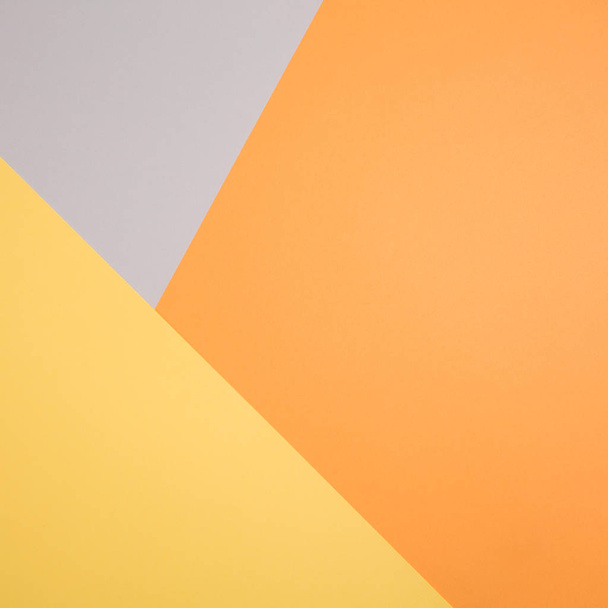 geometric paper background in autumn tones. corners and triangles of gray, yellow, orange colors - Photo, image