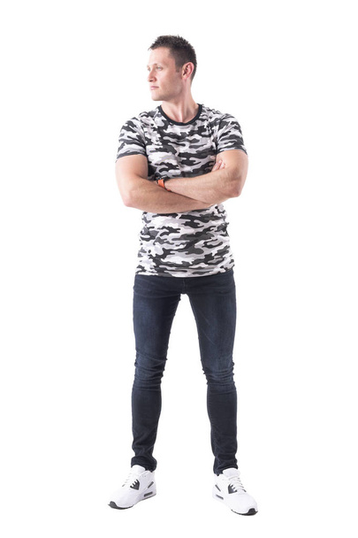 Confident handsome strong man in army shirt with crossed arms looking away. Full body isolated on white background. - 写真・画像