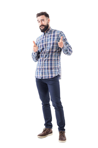 Confident cool friendly bearded guy pointing finger at camera and biting lips. Full body isolated on white background. - Photo, Image