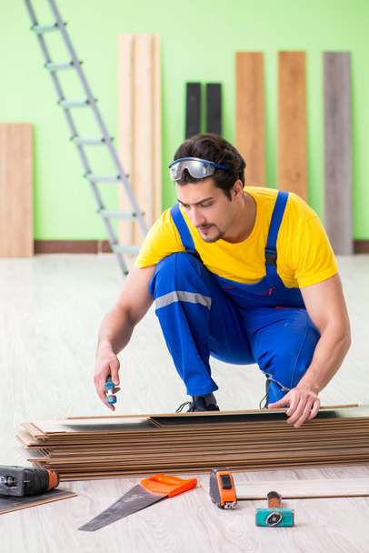 Professional contractor laying flooring at home - 写真・画像