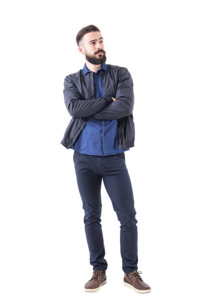 Cool skeptical bearded young man with crossed arms looking away. Full body isolated on white background. - Foto, Imagem