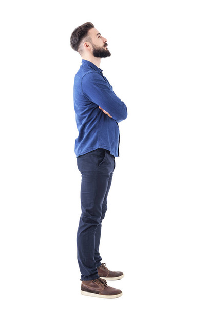 Smart casual bearded business man with crossed arms looking up above. Full body portrait isolated on white background. - Photo, Image