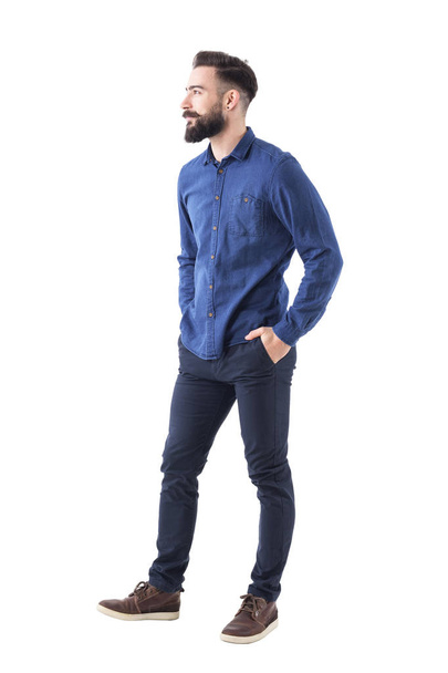 Handsome charming bearded business casual man with hands in pockets looking away and smile. Full body isolated on white. - Φωτογραφία, εικόνα