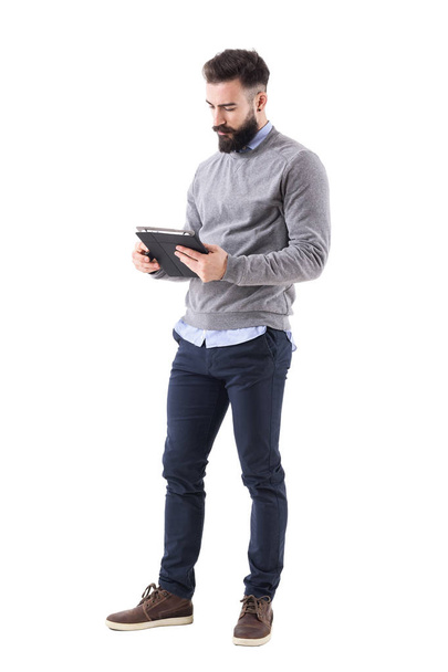 Serious bearded businessman or teacher reading notebook paper. Full body length portrait isolated on white studio background. - Φωτογραφία, εικόνα