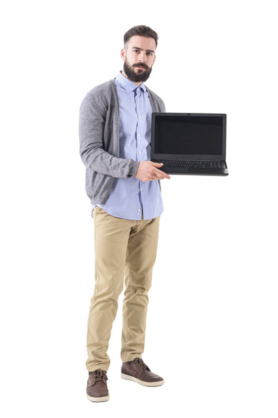 Serious professional businessman showing laptop screen and looking at camera. Full body length portrait isolated on white studio background. - Foto, immagini