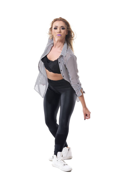 Sweaty passionate energetic female aerobics dancer with tousled hair looking at camera. Full body length portrait isolated on white studio background. - Fotó, kép