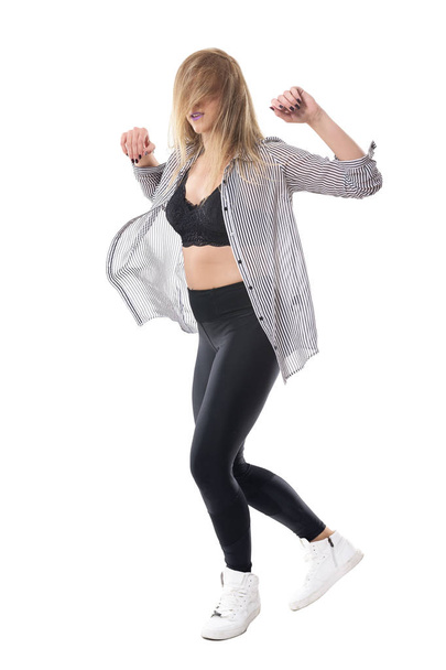 Energetic female jazz dancer dancing with blonde tousled hair flowing over face. Full body length portrait isolated on white studio background. - Foto, imagen