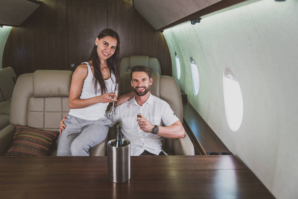 Couple on vacation, flying on their private jet - Fotografie, Obrázek