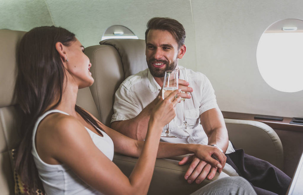 Couple on vacation, flying on their private jet - Valokuva, kuva