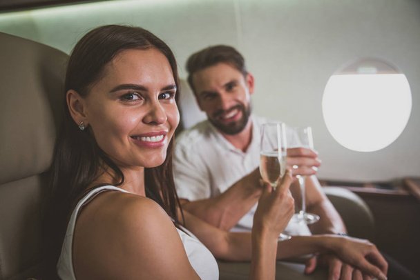 Couple on vacation, flying on their private jet - Photo, image