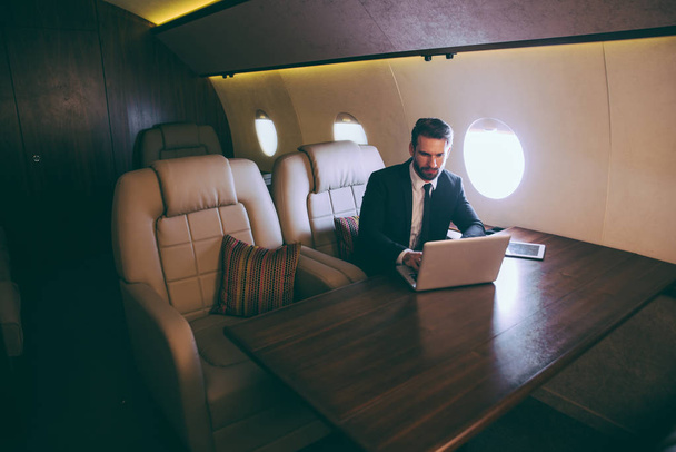 Businessman flying on his private jet - Photo, Image