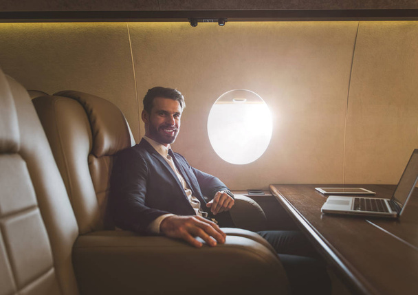 Businessman flying on his private jet - Foto, immagini