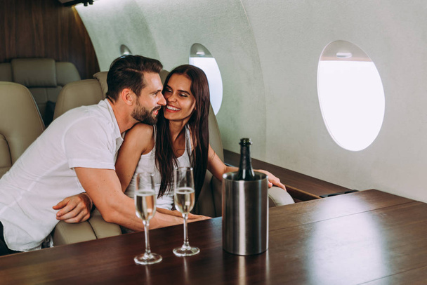 Couple on vacation, flying on their private jet - Фото, зображення