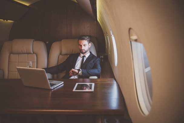 Businessman flying on his private jet - 写真・画像