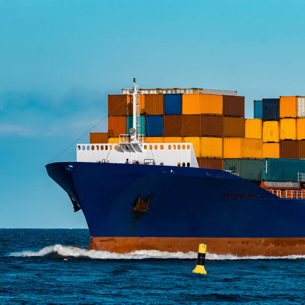 Blue container ship in travel. Logistics and freight industry - Φωτογραφία, εικόνα