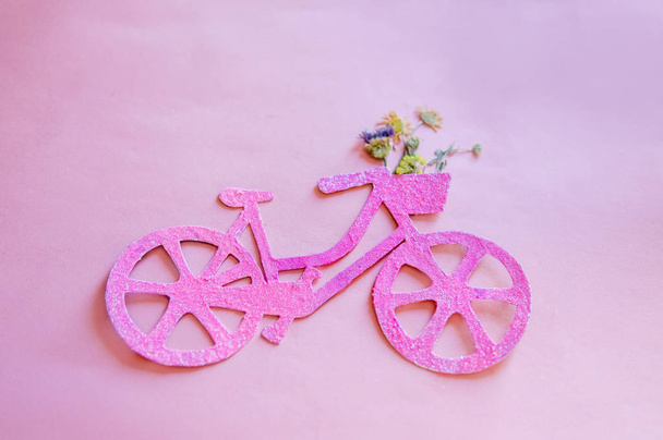 Lady on city bike concept. Minimal style pink bike over pink background - Фото, зображення
