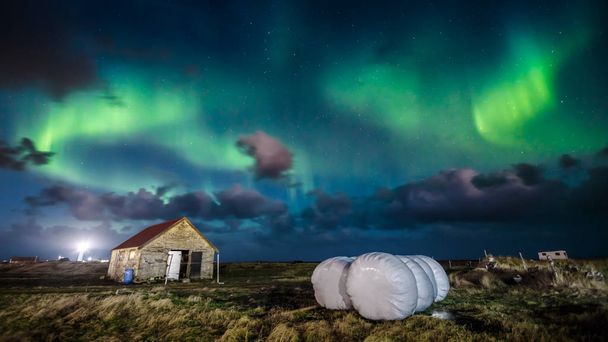 Northern lights (Aurora borealis) over farm house, Iceland - Fotó, kép